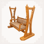 Premium golden polish teakwood swing with intricately carved frame, handcrafted Indian jhoola exported to USA and UK homes.