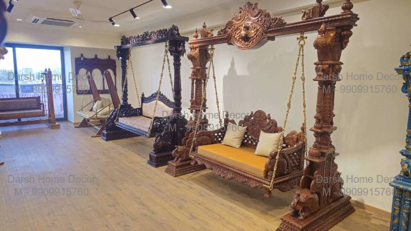 Premium handcrafted Indian wooden swing with ornate carved pillars and golden cushion seating, export-quality cultural jhoola for traditional homes worldwide.