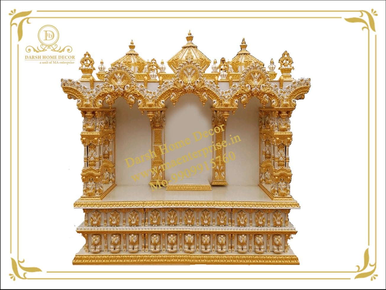 A beautiful white and gold teak wood mandir (Hindu temple) for home worship, featuring three arched alcoves, ornate golden carvings, and multiple decorative domes. The mandir has a multi-layered base with intricate golden accents. The background is solid white.