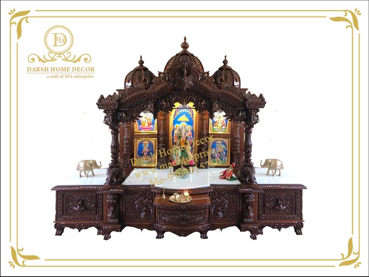 Picture3 A magnificent dark wooden temple set on a matching carved cabinet base, shown decorated for worship with images of Hindu deities, brass elephants, and an oil lamp.